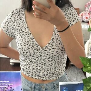 White v cut crop w black flower